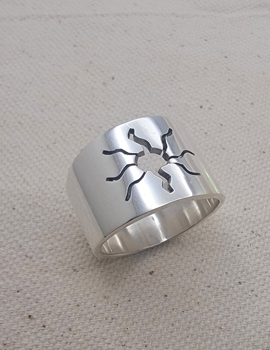Close-up view of the 925 Sterling Silver Wideband Sunburst Ring showcasing its striking sun cutout design on a bold silver band. This artisan jewelry piece is perfect for casual wear, adding a modern touch to your summer jewelry collection with its unique silver ring style.
